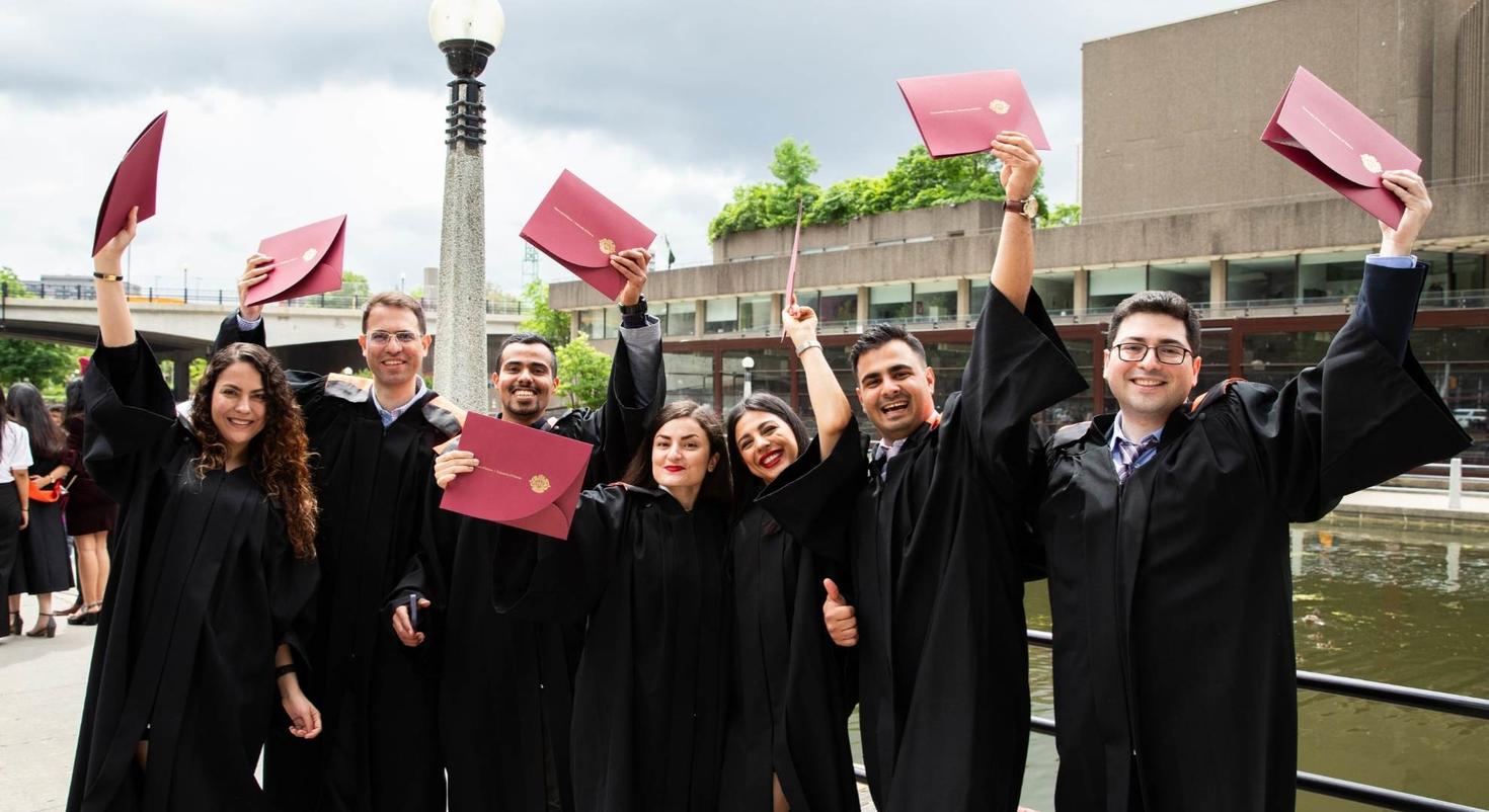 Students holding their diploma.