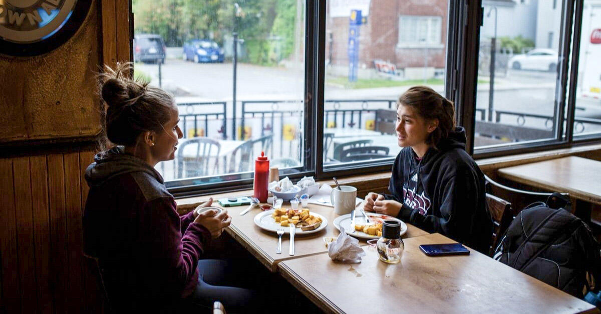 Two students eating breakfast at Father and Sons restaurant.