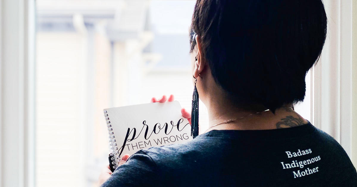 Keri Cheechoo holds a notebook with the words 