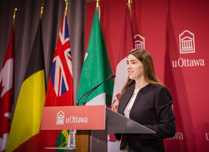 Émilie Cousineau adressing the public on the Huguette Labelle room podium