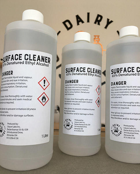three bottles of the surface disinfectant created by Dairy Distillary