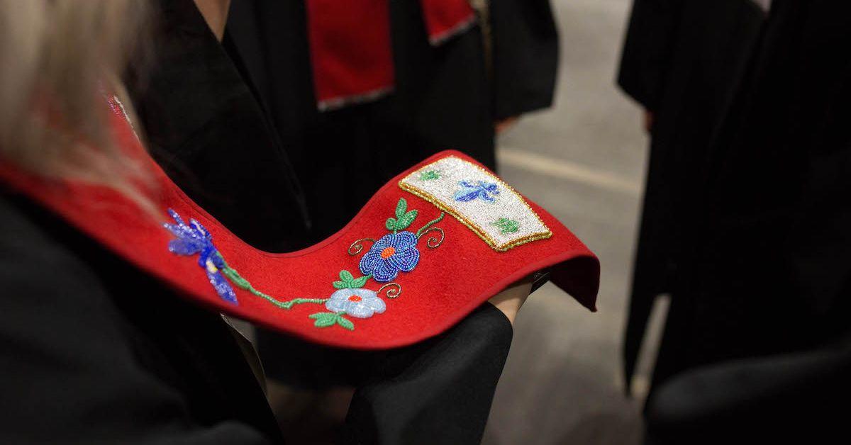 Symbols beaded on a wool scarf.