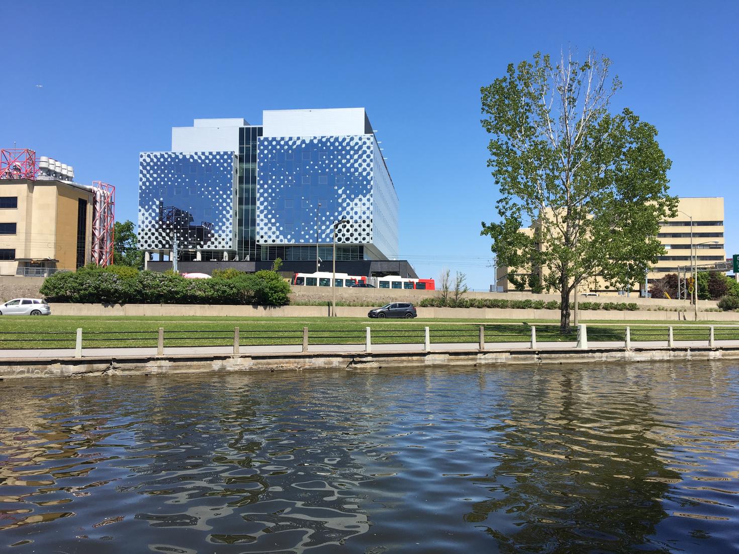 A pair of eyes illustrated on the outside wall of a glass building.