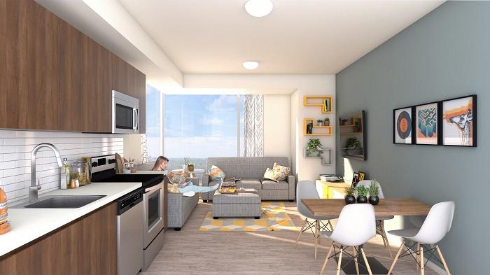 An open plan kitchen and living room, featuring modern appliances and large windows.