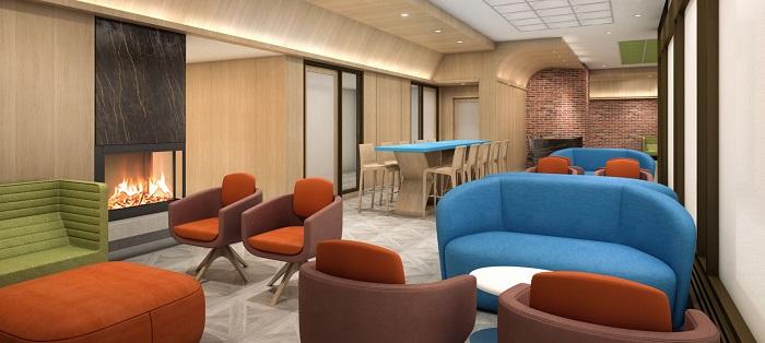 A lobby lounge with fireplace and many chairs and loveseats.