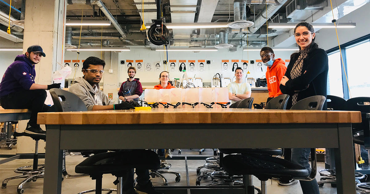 Group of engineering students with the face shields they made