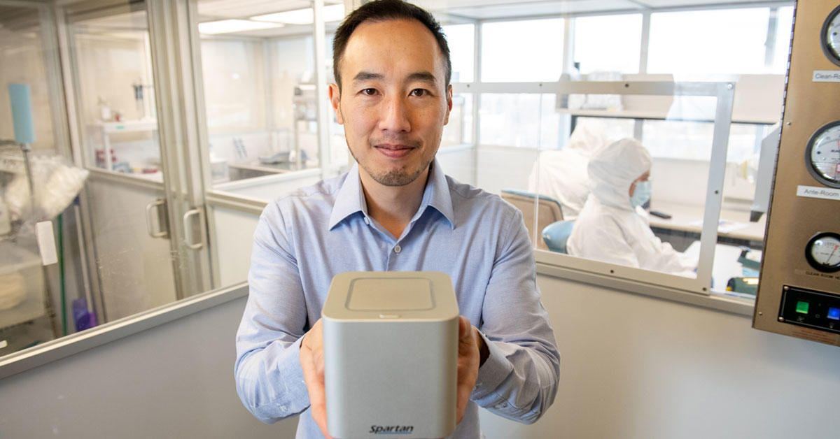 uOttawa alumnus Paul Lem holds up his invention, the Spartan Cube