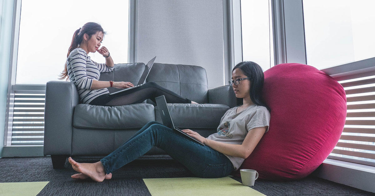 Deux étudiantes se détendent avec des ordinateurs portables
