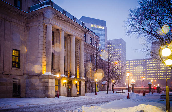 The northern side of Tabaret Hall in winter with the Desmarais Building in the background.